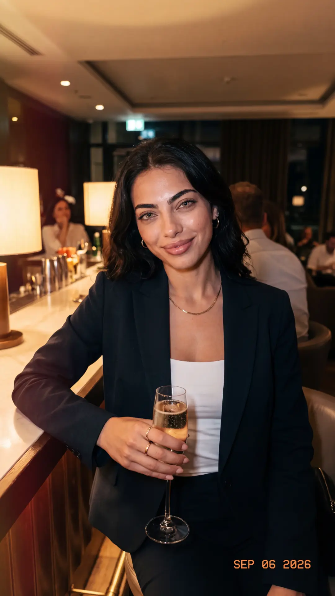 Sera Lanes with a glass of champagne on an evening out