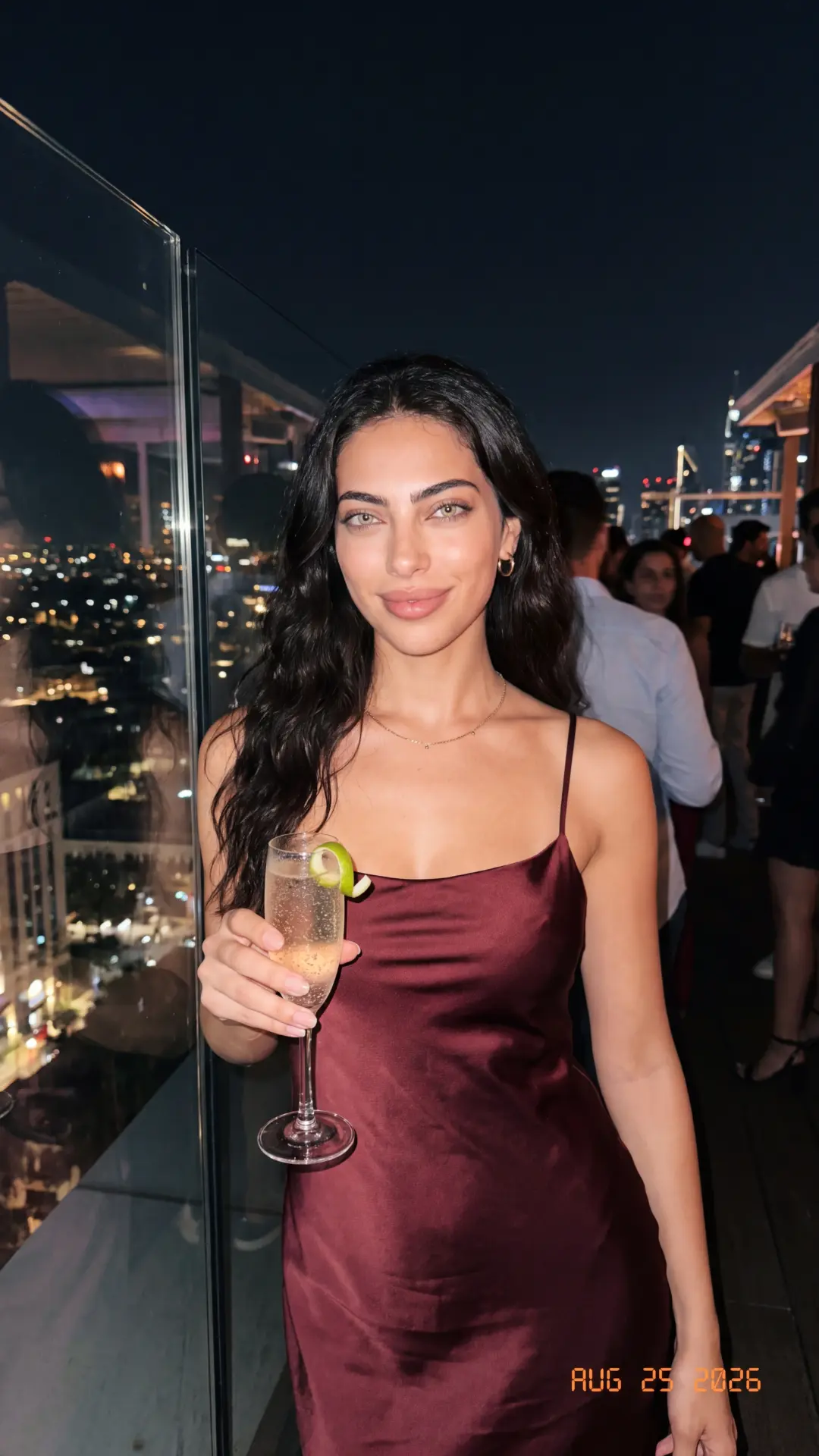 Sera Lanes at a rooftop bar at night with a glass of bubbles
